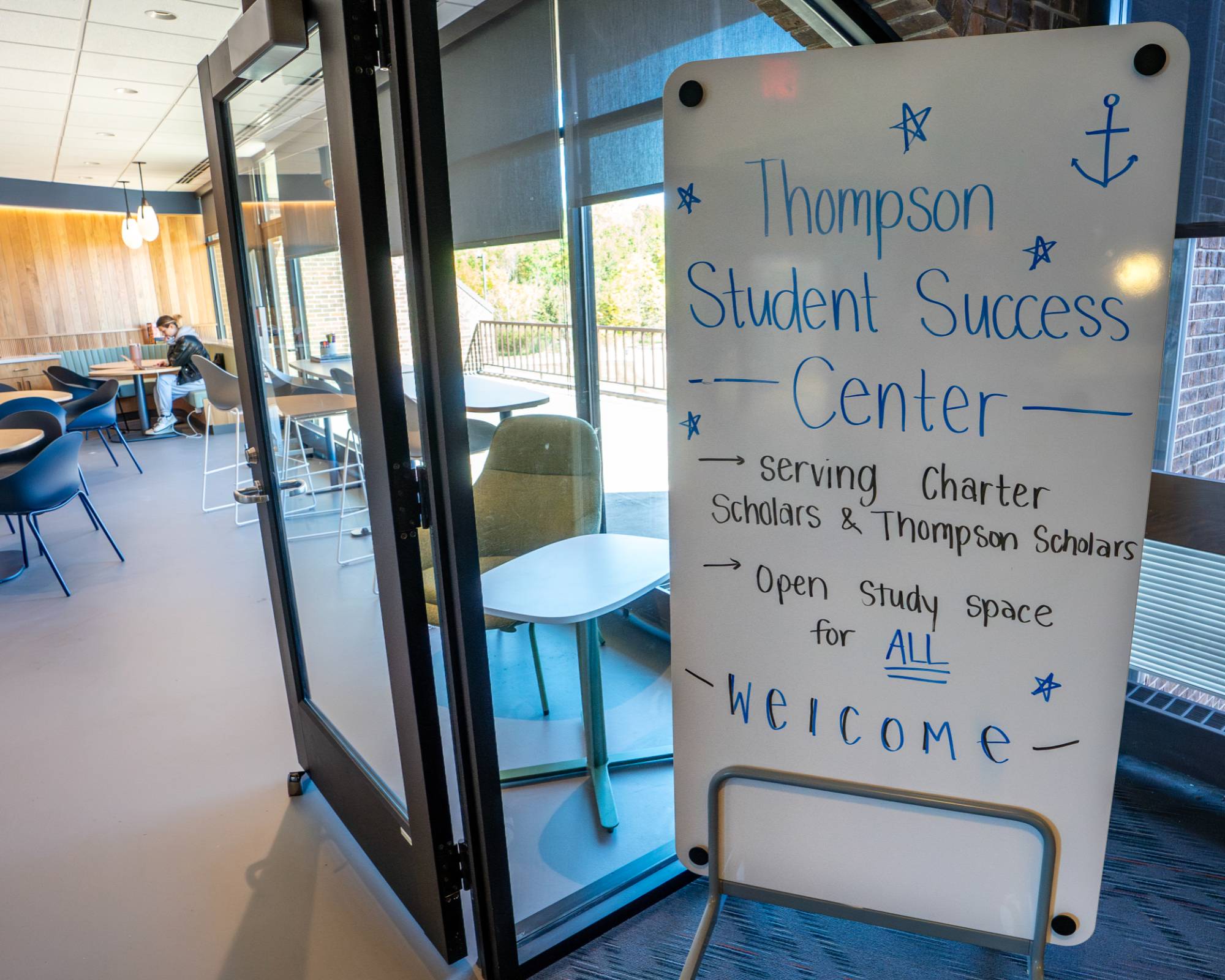 Entrance to the Thompson Student Success Center with a whiteboard with office information